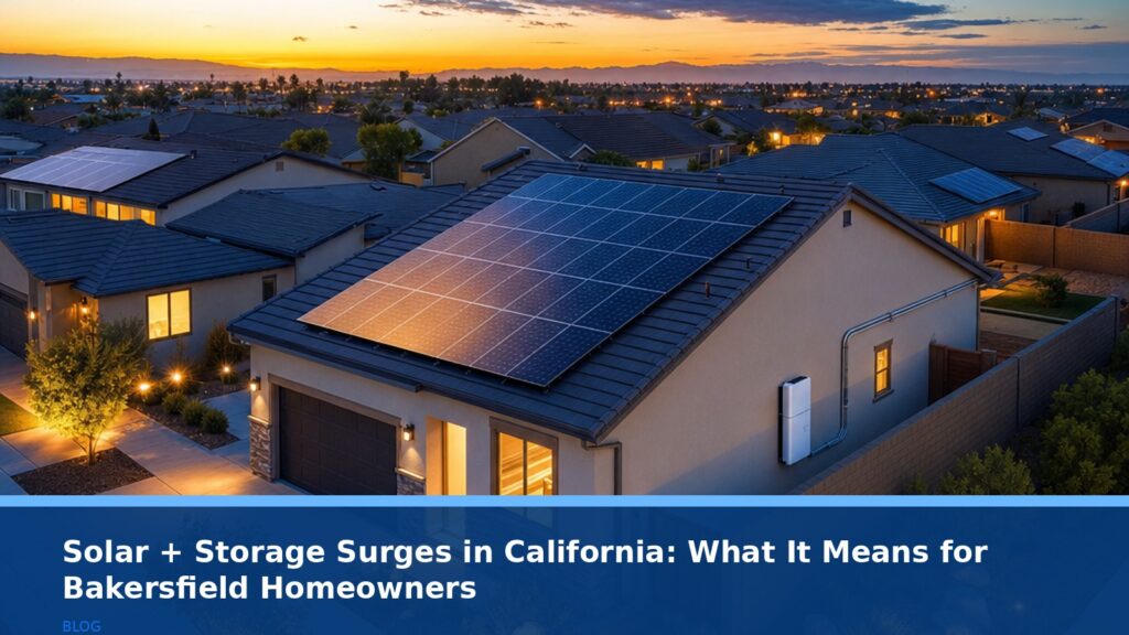 Aerial view of a suburban Bakersfield neighborhood at dusk, with solar panels on several rooftops glowing warmly in the evening light. A home in the foreground has a sleek, modern battery storage unit mounted on its side wall. The scene conveys energy independence and modern technology.